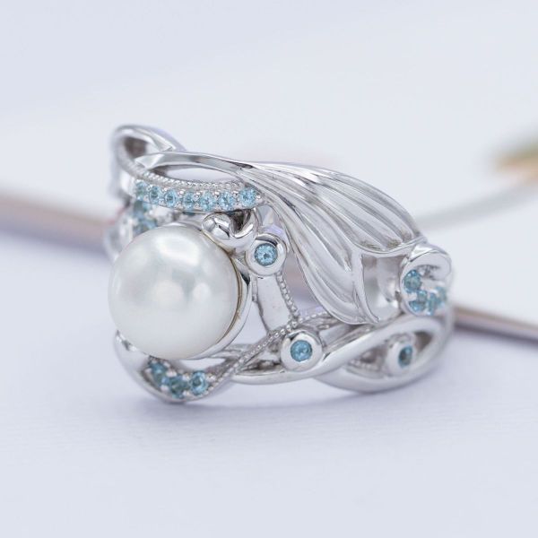 The pearl in this mermaid-inspired ring pairs nicely with the white gold setting and Swiss blue topaz accents.