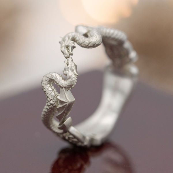 This engagement ring has no stone but features two mirrored serpentine dragons to celebrate Mitchell’s love for three dragon-themed fandoms.