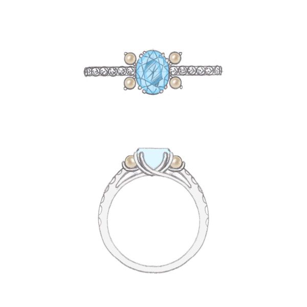 This engagement ring’s white gold double-prongs cradle an oval cut aquamarine as petite pearls decorate either side.