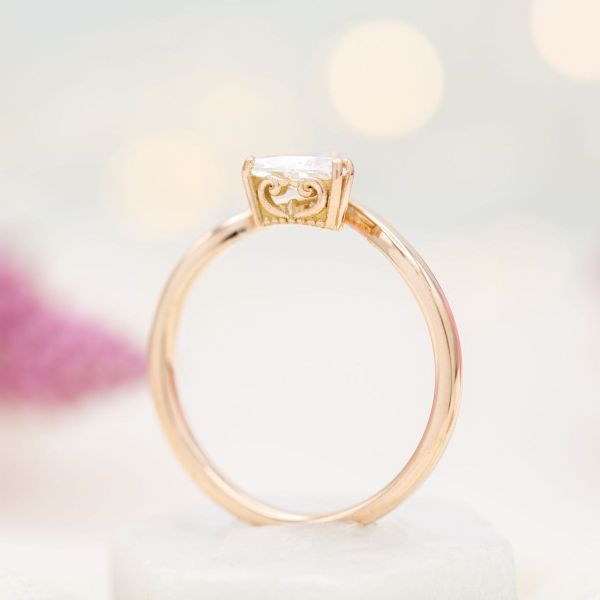 A trillion cut diamond puts a unique spin on the classic diamond solitaire engagement ring.