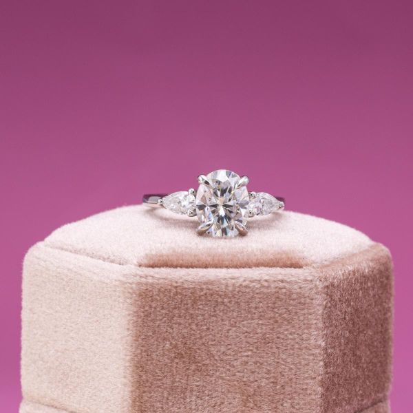 Pear moissanite side stones give a unique twist to this white gold moissanite engagement ring.