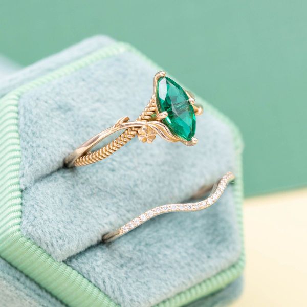 The lab green emerald at the center of this fantasy engagement ring pairs well with the lab diamonds in the matching rose gold wedding band.