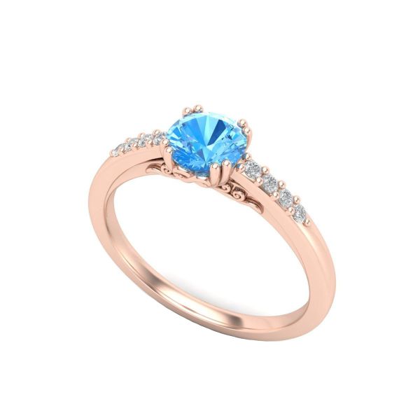 Rose gold double-prongs hold a sky blue topaz as diamond accents dance along this engagement ring’s shoulders.