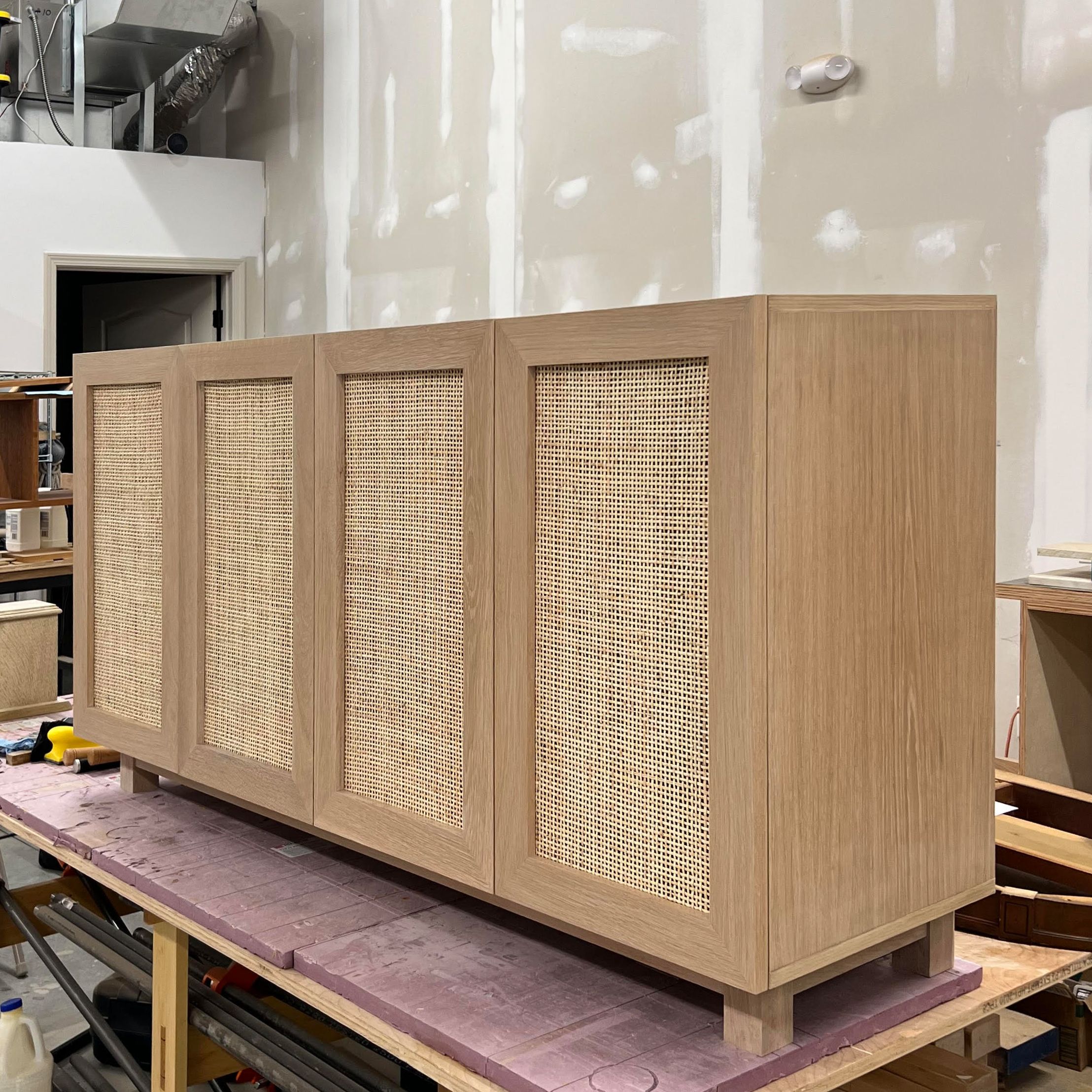 Handmade Coastal Charm White Oak Media Center With Rattan Doors by Dovetails and Stitches