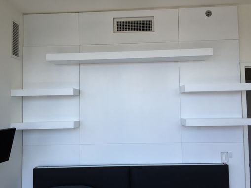 Custom Made Wall Unit With Custom Paneling And Floating Shelves