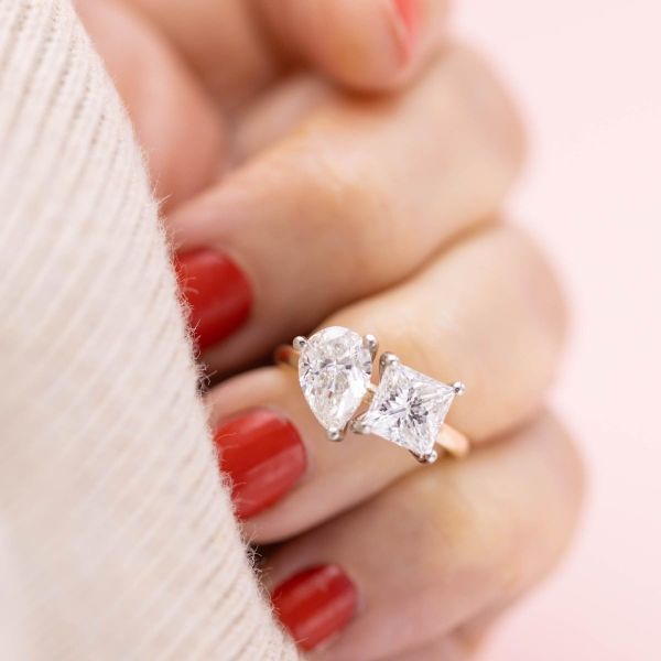 An unusual pairing of diamonds—pear and princess cuts—snuggle and sparkle in this two-stone engagement ring.