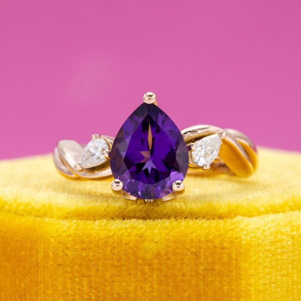 This pear cut amethyst is accented by additional pear cut diamond accents.