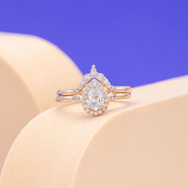 This engagement ring is adorned with a pear shaped lab diamond at its center.