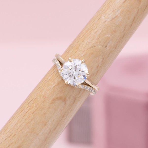 Six prongs hold a this round lab diamond in the center of the solitaire engagement ring.