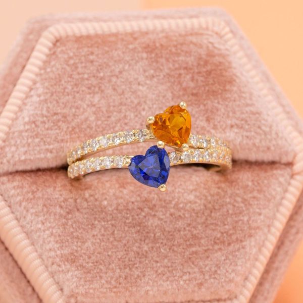 Saying “I do” literally brings two hearts together with this sapphire and citrine bridal set. Yellow gold and moissanite accents are used throughout both bands and the two heart shaped stones nest into each other to create the ultimate romantic union.