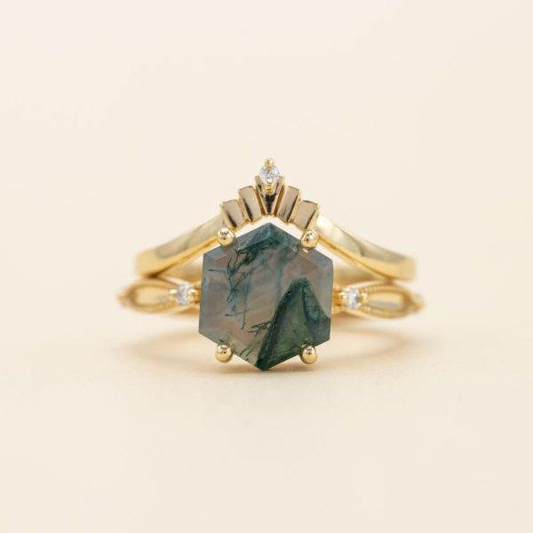 Hexagon cut moss agate and diamond accents are set in a unique yellow gold band.