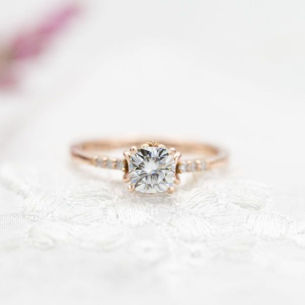 This traditionally-designed engagement ring features small nods to the deathly hallows and Beauty and the Beast’s enchanted rose.