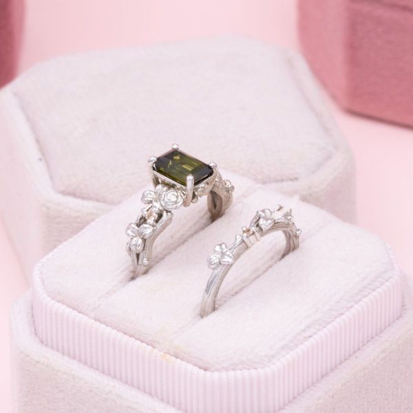 The green tourmaline center stone grows out of this couple’s tree themed engagement ring.