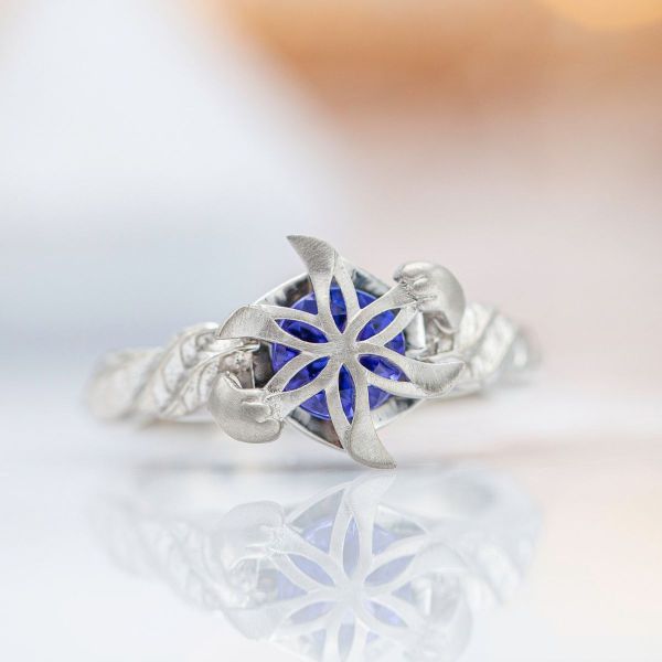 A blue tanzanite center stone is supported by cute kitty paws in this Nenya inspired ring.