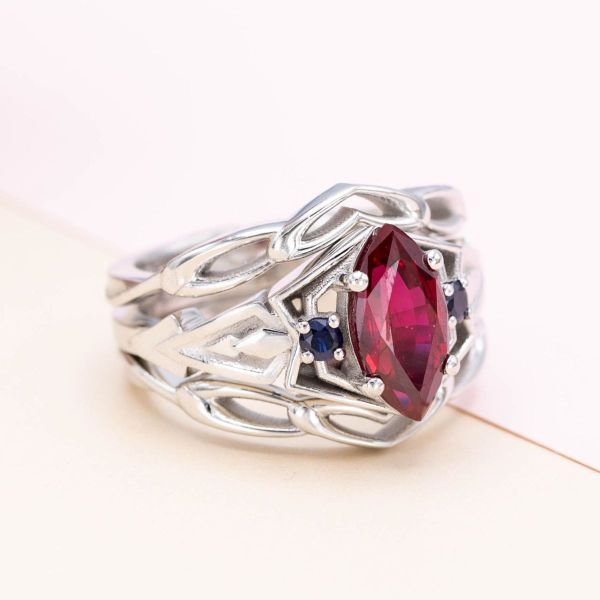 A ruby center stone is flanked by deep blue sapphires in this Spider-man and Venom inspired engagement ring.