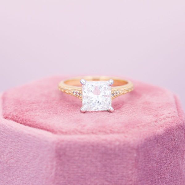 A yellow gold band supports the white gold setting in this mixed metal engagement ring.