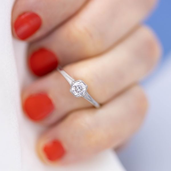 A lab diamond sits in the center of this dainty engagement ring.