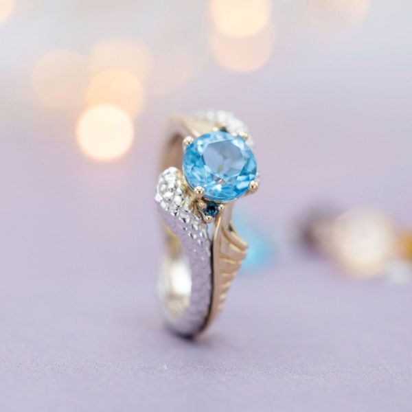 The Swiss blue topaz is set in a unique white and yellow gold band.