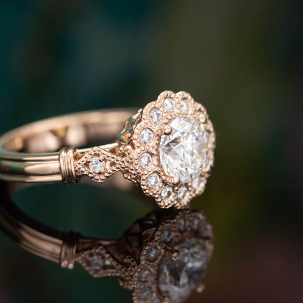 Vintage-inspired rose gold and diamond ring, with scalloped halo and milgrain accents.