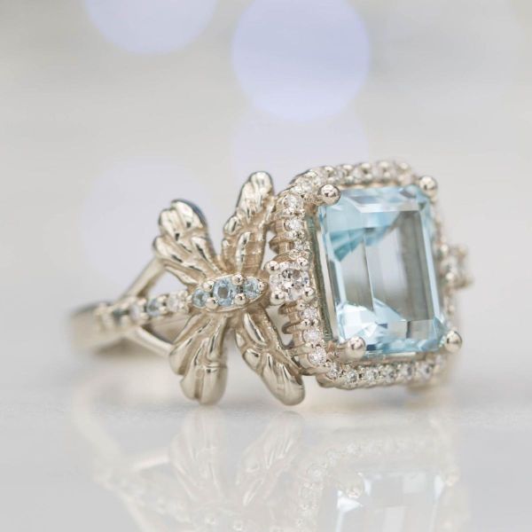 Dragonflies make up the sides of the band on this aquamarine center stone ring.
