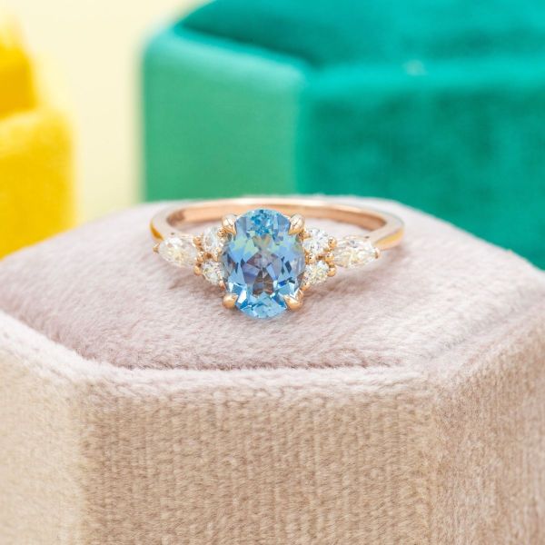 This deeply saturated aquamarine takes center stage when supported by accent diamonds on this yellow gold engagement ring.