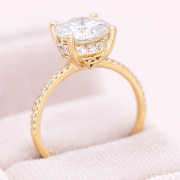 This moissanite-filled engagement ring is all about the sparkle with a peekaboo trinity knot.