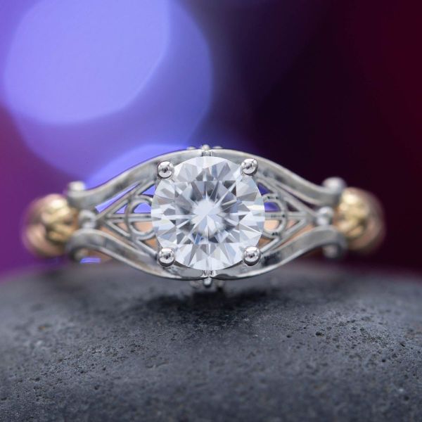 A moissanite center stone dazzles in this ring with a band crafted to look like Ron and Hermione’s wands.