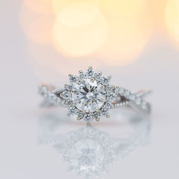 We chose diamonds in this ring's sunburst halo at the same color grade as the center stone, to avoid highlighting any tint in the center stone.