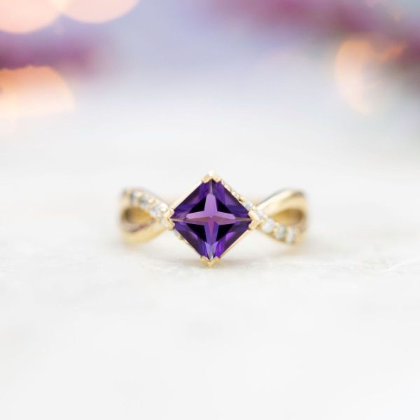 This amethyst engagement ring is set in yellow gold.