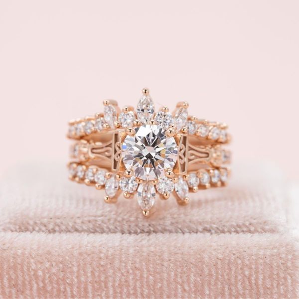 A lab created diamond shines brightly in the center of this intricate bridal set.