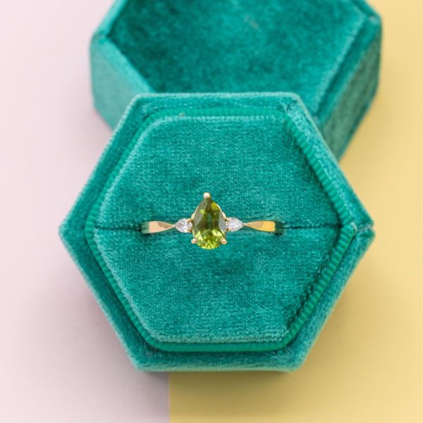 This yellow gold band features a peridot with two marquise side diamonds.