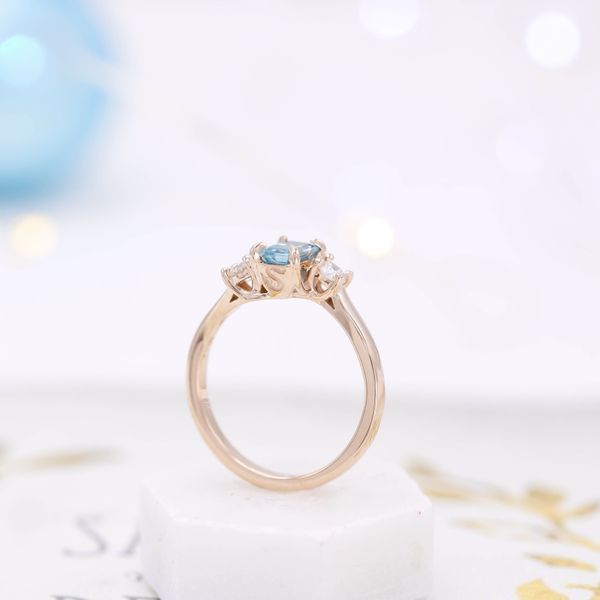 The blue zircon and diamond accents hide a snakey secret in this engagement ring.