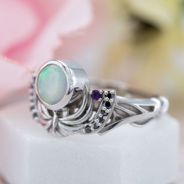 Night is the theme in this engagement ring, with a moon-white opal center stone and nightingale detailing inspired by Skyrim.