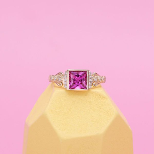 A bright pink princess cut sapphire engagement ring.