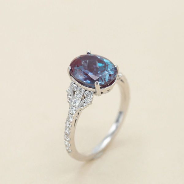 Diamonds accent the center alexandrite in this white gold engagement ring.