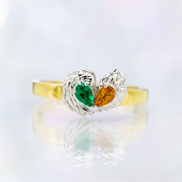 This pairs contrasts green emerald and orange citrine, forming a heart with the pear cut stones.