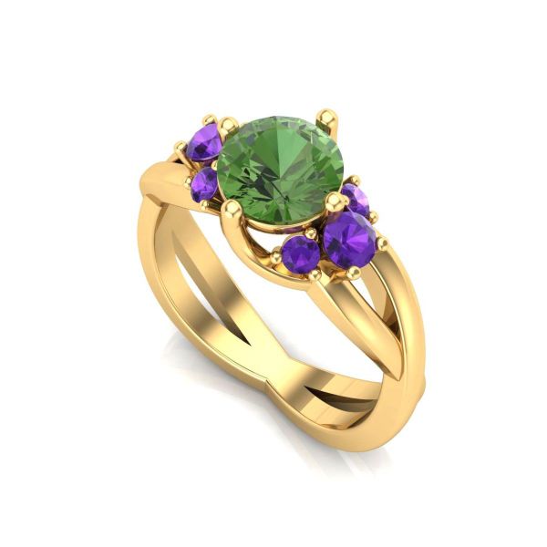 A bouquet of gemstones – amethysts and a green tourmaline – pop out from a yellow gold band in this witchy engagement ring.