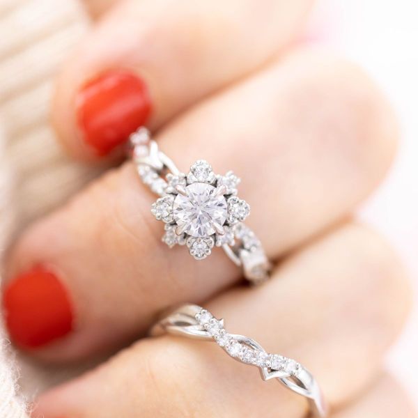 A sunburst halo turns this diamond and platinum engagement ring into an everlasting snowflake.