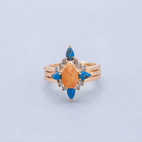 This ring set is out of this world with its bold color combo of Oregon sunstone, turquoise and salt-and-pepper diamonds