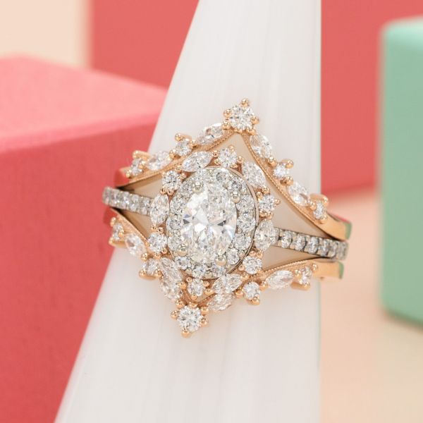 Layer upon layer of vintage-inspired sparkle dazzles in this double-halo engagement ring with two regal bands.