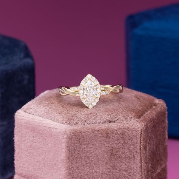 This vintage inspired engagement ring boasts a lab created marquise cut diamond.