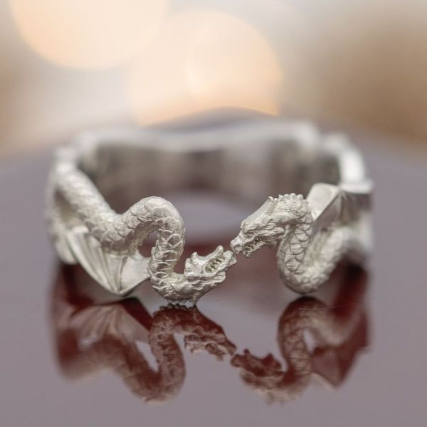 This engagement ring has no stone but features two mirrored serpentine dragons to celebrate Mitchell’s love for three dragon-themed fandoms.