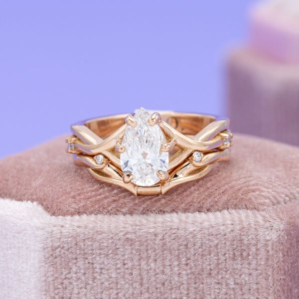 This pear shaped diamond engagement ring features a natural mined diamond.