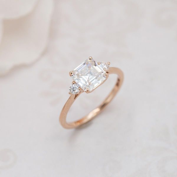 A white Asscher moissanite in a rose gold setting.