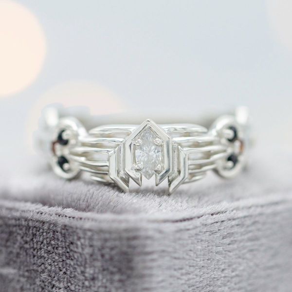 Geometric patterns surround the diamond in this Mass Effect inspired engagement ring.