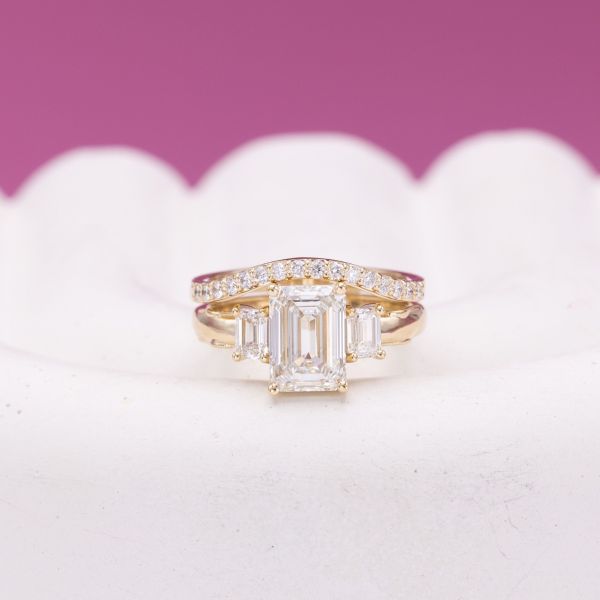 Are you getting good at this guessing game? The emerald cut stone in the center of this ring is a lab created diamond.