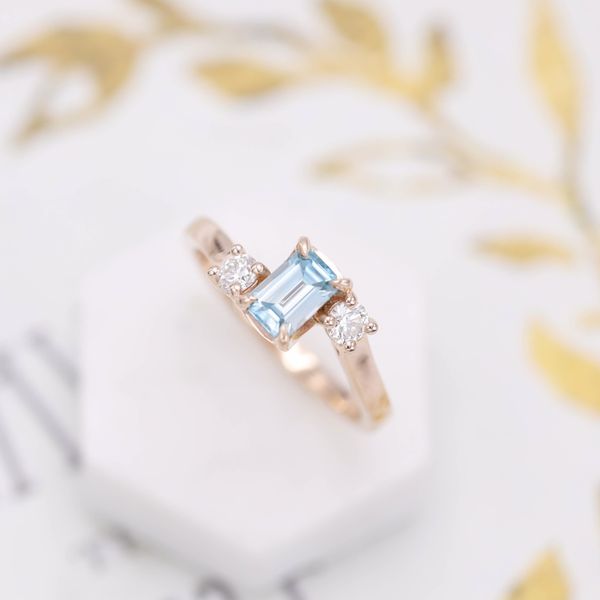 The blue zircon and diamond accents hide a snakey secret in this engagement ring.