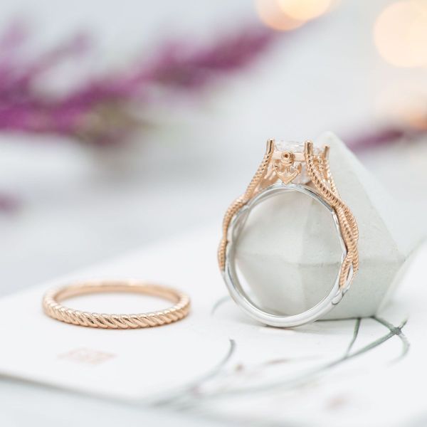 The diamond center and accents of this bridal set complement the tightly woven mixed metal bands and anchor details of these nautical rope-inspired rings.