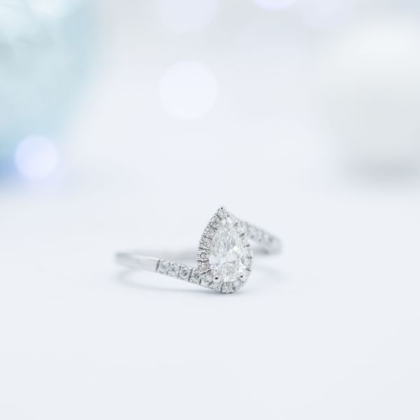 The halo and pavé diamonds surrounding the pear-shaped center stone add about $800 to the final cost of this ring. A similar set of lab-created diamonds would have cost closer to $600.