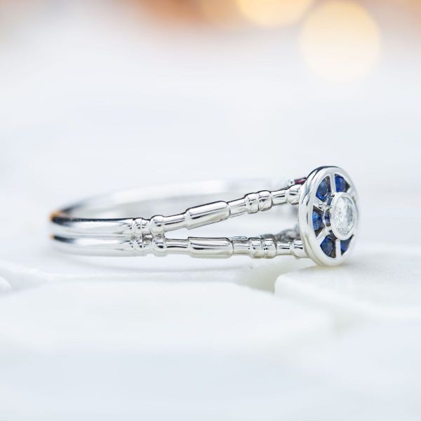 A round cut moissanite and six surrounding sapphires resemble R2D2 in this Star Wars inspired ring.